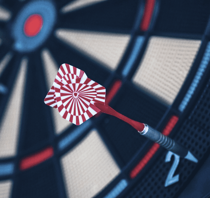 Dartboard with a dart hitting the bullseye